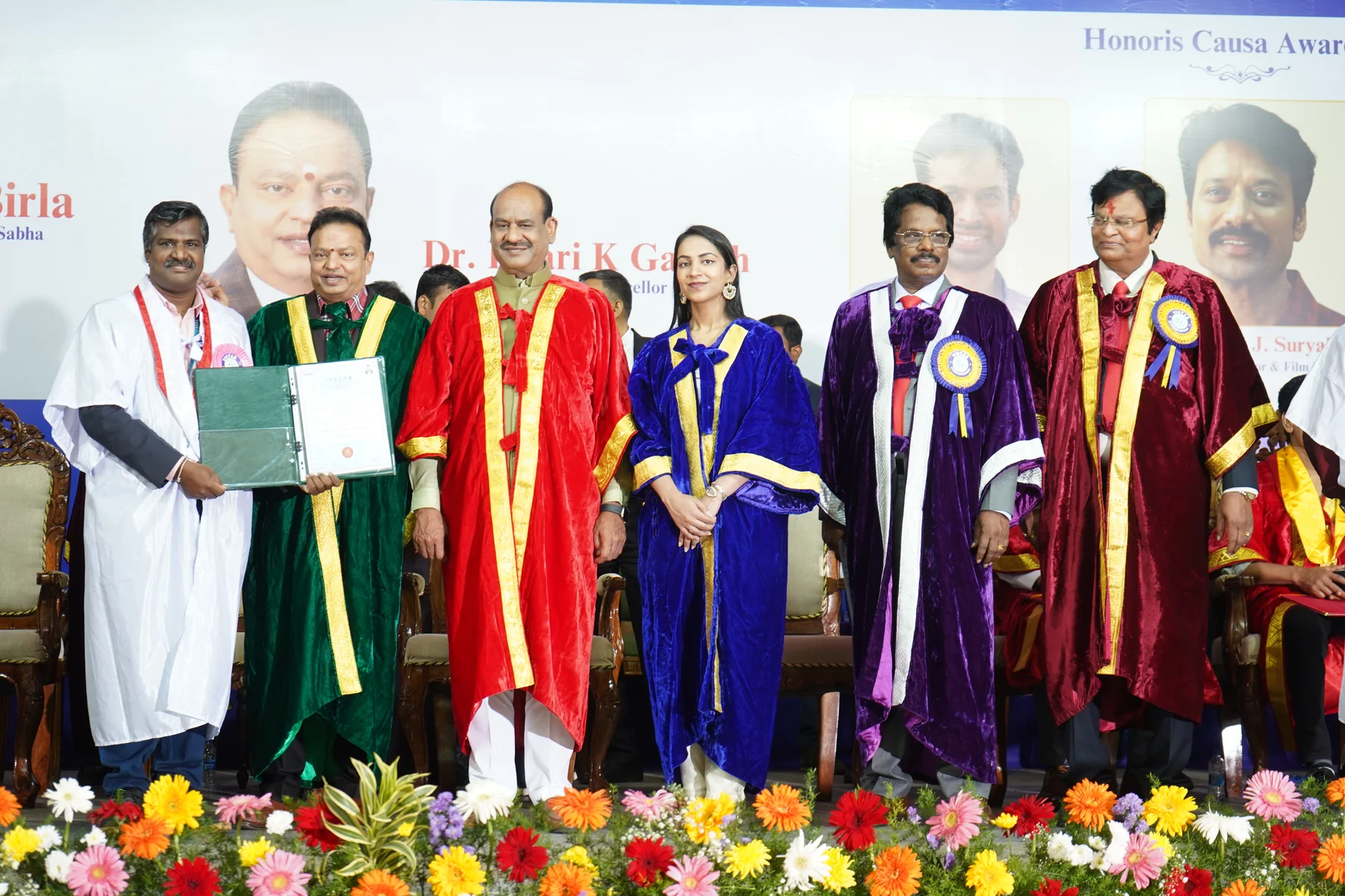 Astro Dr. Chandrasekar holding a certificate during a formal convocation and recognition ceremony